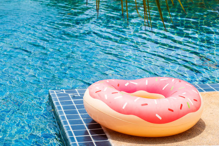 Near the blue swimming pool are pink circle. The concept of remote work and vacation, vacation