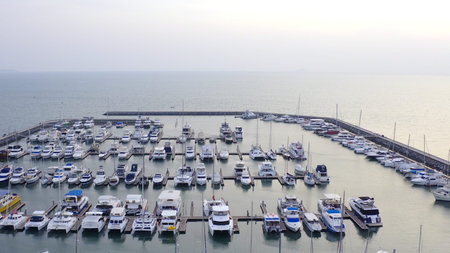 Aerial View by Drone of Yacht Club and Marina. Top view of yacht club. White boats in sea water. Marina dock yachts and small moto. Yacht and sailboat.の写真素材