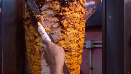Shawarma. Closeup picture of stacked meat roasting, shawarmaの写真素材
