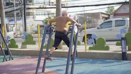 Pattaya, Thailand - May 26, 2019: active senior male runs, goes in for sport regularly, breathes fresh air in countryside. Mature runner has healthy lifestyle.のeditorial素材