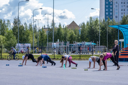 Nizhnevartovsk, Russia - August 27, 2019: Fitness woman jumping outdoor in urban environmentのeditorial素材