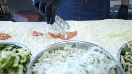 The process of preparing shawarma, the cook puts the ingredients. Close up.
