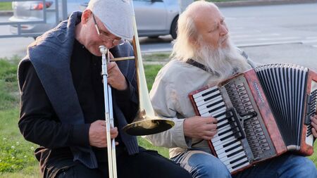 Nizhnevartovsk, Russia - August 25, 2019: street musicians play the button accordion and trumpet.のeditorial素材