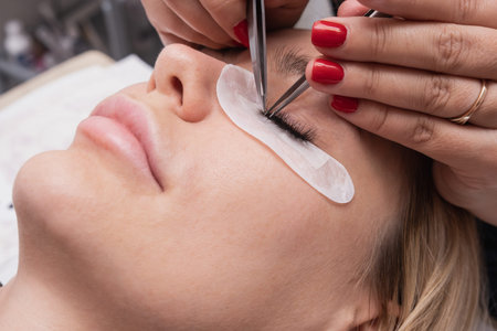 Artificial eyelash extensions from the master of eyelash extension in the beauty salon, medical...