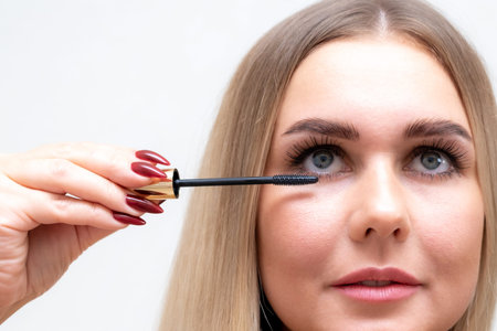 Female eyes with mascara brush. Female eyes with long eyelashes and a mascara brush