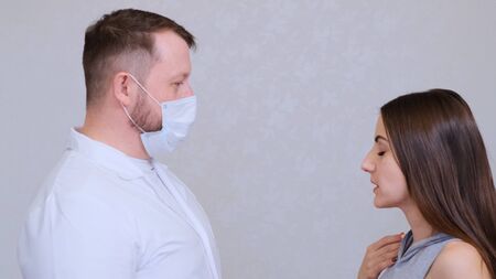 Sick woman and doctor man talking, copy space. Medicine and health concept. Diagnose the patientの写真素材