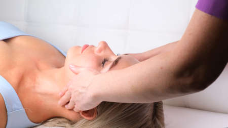 Beautiful woman in salon having facial massageの写真素材