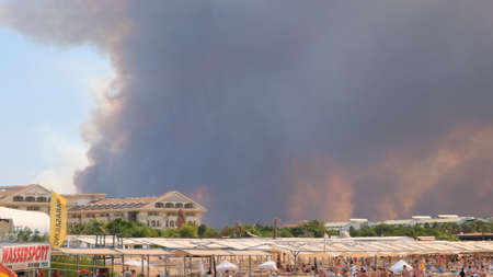 Flames and smoke from wildfires cover the landscape. Clouds of smoke over hotels and over the sea: Antalya, Manavgat Turkey - July 28, 2021のeditorial素材