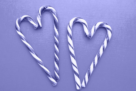Two striped heart shaped lollipops on the background, Very Pure tone image. Valentines Day. copy...