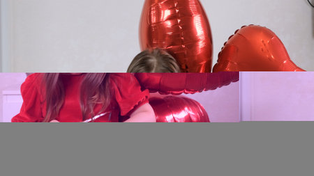 sad little girl in red dress with three heart shaped balloons for valentines day. family love. gifts for the holiday. happiness and kisses.の写真素材
