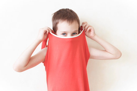 boy in dress. boy trying on women's clothes, boy wearing a woman's dressの写真素材