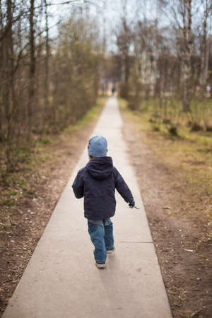 child escape. the child runs on a path in parkの写真素材