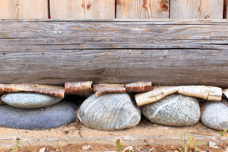 Foundation. layered Foundation of a house made of wood, stones and barkの写真素材