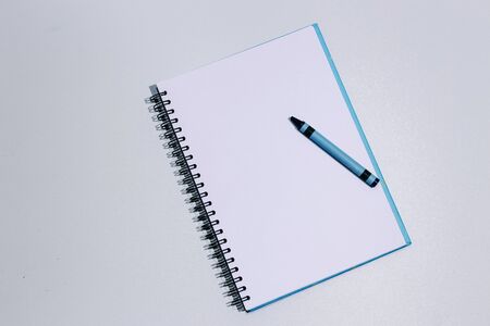 White clean notebook blue crayon on textured gray table with copy space, top viewの写真素材