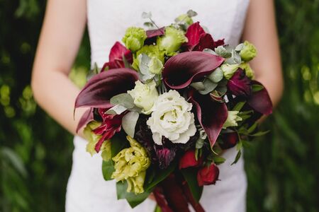 picture young woman keeping wedding bouquet park summerの写真素材