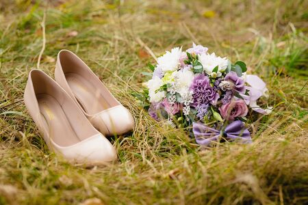 Beautiful wedding bouquet with bow-tie on the grass.の写真素材