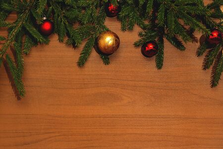 Fir brunch on wooden background with christmas balls wih place for text. New year decoration background, flat lay, top view, horizontal, copy spaceの写真素材