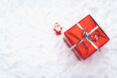 Christmas holiday decor with Santa figurine and gift.  flat lay, top view, horizontal, copy space