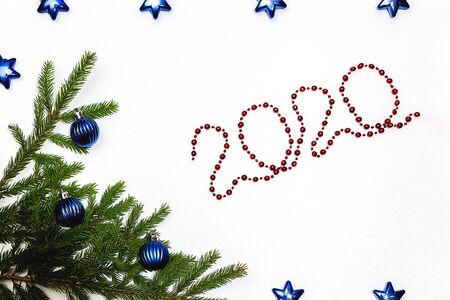 Christmas gift box and holiday decor with fir tree brunch and red balls. New year decoration background on the artificial snow, flat lay, top view, horizontal, copy space. 2020の写真素材