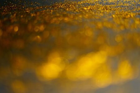 golden glitter sparkle isolated on black backgroundの写真素材