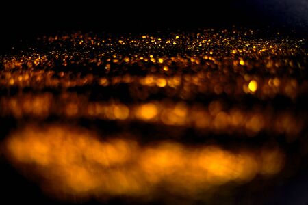golden glitter sparkle on black background. Isolated. Flat lay. Christmas background. New year decoration. wallpaper. Copy spaceの写真素材