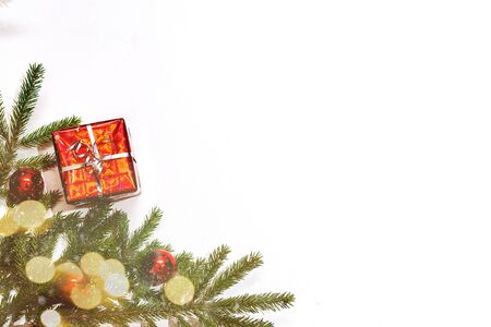 Christmas gift box and holiday decor with fir tree brunch and red balls. New year decoration background on the artificial snow, flat lay, top view, horizontal, copy spaceの写真素材
