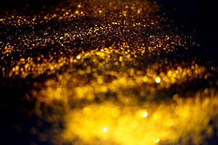 golden glitter sparkle on black background. Isolated. Flat lay. Christmas background. New year decoration. wallpaper. Copy spaceの写真素材
