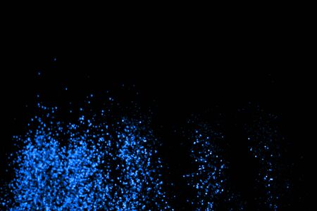 blue glitter sparkle on black background. Isolated. Flat lay. Christmas background. New year decoration. wallpaper. Copy spaceの写真素材