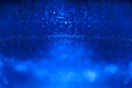 blue glitter sparkle on black background. Isolated. Flat lay. Christmas background. New year decoration. wallpaper. Copy spaceの写真素材