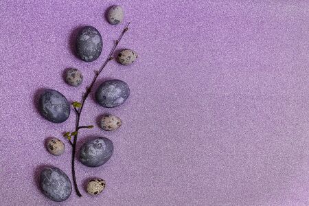 Eggs with marble stone effect painted with natural dye carcade flower on lilac sparkling backgroundの写真素材