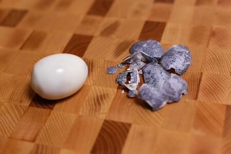 Egg with marble stone effect painted with natural dye carcade flower on wooden backgroundの写真素材