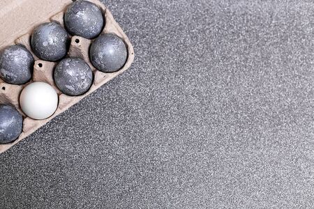 Eggs with marble stone effect painted with natural dye carcade flower on grey sparkling backgroundの写真素材