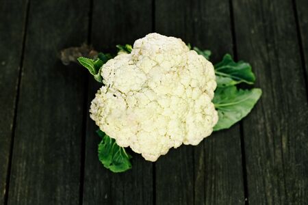 Cauliflower on wooden surface. Seasonal vegetables. Fresh vegetables. Healthy diet.の写真素材