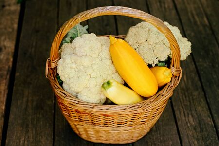 Squash and cauliflower on wooden surface in the basket. Seasonal fresh vegetables.Fresh vegetables. Healthy diet. Copy spaceの写真素材