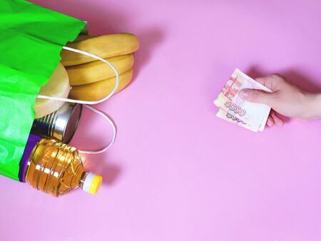 Food delivery. Hands in gloves. Coronavirus, COVID 19. Paper bag with eco foodの写真素材