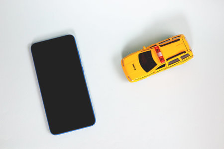 Yellow toy taxi car model. idea, symbol, concept of urban service and delivery. Copy space. Mobile...