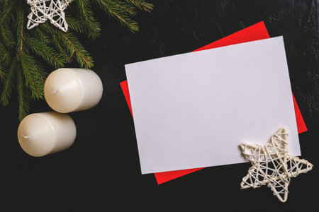Christmas composition with brunches, candles, stars and paper for text on dark background with red glitter.の写真素材