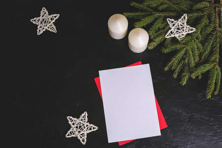 Christmas composition with brunches, candles, stars and paper for text on dark background.の写真素材