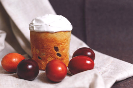 Easter pastries and colored eggs on a textile background. Spring composition. Traditional pastries for Orthodox holidays.の写真素材