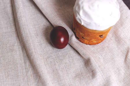 Easter pastries and colored eggs on a textile background. Spring composition. Traditional pastries for Orthodox holidays.の写真素材