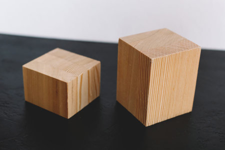Natural mockup of wooden cubes for cosmetics on black and white background. Copy space for text....