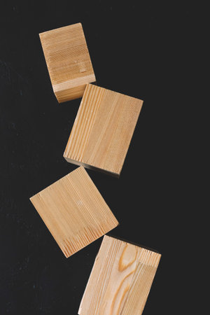 Natural mockup of wooden cubes for cosmetics on black background. Copy space for text. Beauty...