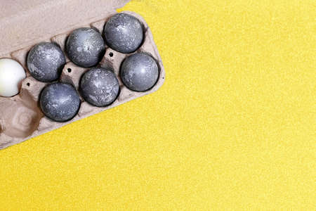Eggs with marble stone effect painted with natural dye carcade flower on grey sparkling backgroundの写真素材