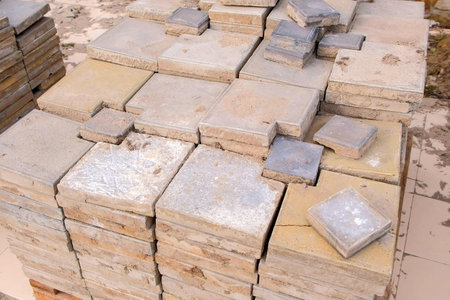 Accomplishment of territory. Laying paving slabs in pile on sidewalk in city park.の写真素材