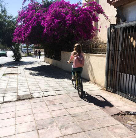 Girl rides a bicycle on the street of Jordan. Aqaba. Tourism.のeditorial素材