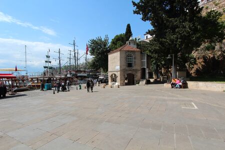Tourist port in Antalya. Old city. People walk in the square and sit on a bench.のeditorial素材