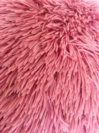 The texture of red natural fluffy soft fabric. Close-up. Background for design and creativity.