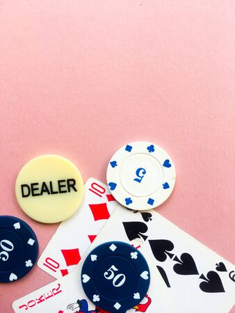 Poker chips and cards on a pink background. The game of poker. Chip dealer. Gambling. Place for text.のeditorial素材