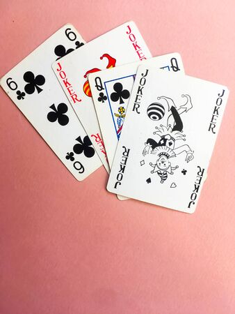Cards for playing poker are at the top of the pink background. Place for text. Gambling.のeditorial素材