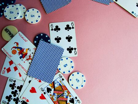 Poker chips and cards on a pink background. The game of poker. Chip dealer. Gambling. Place for text.のeditorial素材